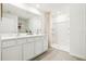This bathroom features double sinks, large mirror, white cabinets, and shower at 6052 Shiprock Ave, Spring Hill, FL 34608