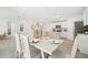 Inviting dining room with neutral decor, a dining table set for six, and seamless access to the kitchen and living areas at 6052 Shiprock Ave, Spring Hill, FL 34608