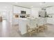 Bright, modern kitchen boasts white cabinets, stainless steel appliances, and a breakfast bar with stylish seating at 6052 Shiprock Ave, Spring Hill, FL 34608