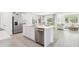 Open concept kitchen features stainless appliances, center island with barstool seating, and easy access to living area at 6052 Shiprock Ave, Spring Hill, FL 34608