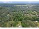 Aerial view reveals a house surrounded by mature trees, offering a blend of privacy and natural beauty at 8309 Oakgren Rd, Brooksville, FL 34601
