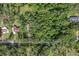 Aerial view of a wooded area with houses, providing a sense of community and natural surroundings at 8309 Oakgren Rd, Brooksville, FL 34601