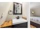 Bathroom with modern sink, wood countertop, and view into the bedroom at 8309 Oakgren Rd, Brooksville, FL 34601