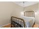 Cozy bedroom with brass bed frame and ceiling fan providing comfortable and restful space at 8309 Oakgren Rd, Brooksville, FL 34601