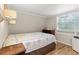 Bright bedroom with hardwood floors, comfortable bed, and a large window at 8309 Oakgren Rd, Brooksville, FL 34601
