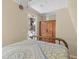 Serene bedroom with brass bed frame offering a peaceful retreat with view of kitchen at 8309 Oakgren Rd, Brooksville, FL 34601