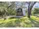 Quaint A-frame home with expansive deck nestled among lush trees, creating a serene setting at 8309 Oakgren Rd, Brooksville, FL 34601