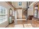 Bright living room with hardwood floors, a spiral staircase, and comfortable seating at 8309 Oakgren Rd, Brooksville, FL 34601