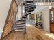Open concept living space with spiral staircase, hardwood floors, and bar seating at 8309 Oakgren Rd, Brooksville, FL 34601