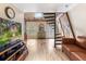 Stylish living room with a spiral staircase, hardwood floors, and charming decor at 8309 Oakgren Rd, Brooksville, FL 34601