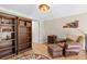 Comfortable sitting room with hardwood floors, leather furniture, and custom bookshelves at 8309 Oakgren Rd, Brooksville, FL 34601