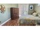Bedroom featuring wood floors, a large dresser, and sliding glass doors to the outside at 1138 Lumsden Trace Cir, Valrico, FL 33594