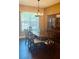 Dining room with hardwood floors, chandelier, and large window allowing natural light at 1138 Lumsden Trace Cir, Valrico, FL 33594