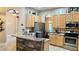 Open kitchen features stainless steel appliances, wood cabinets, and a breakfast bar counter at 1138 Lumsden Trace Cir, Valrico, FL 33594