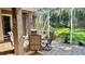Screened patio with tile flooring, seating, and view of the lush green backyard at 1138 Lumsden Trace Cir, Valrico, FL 33594