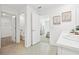 Well-lit bathroom with tiled floors, dual sinks, and separate access to the water closet and bedroom at 11758 Memorial Dr, Brooksville, FL 34613