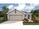 Charming single-Gathering home showcasing a two-car garage, landscaped yard, and attractive architectural design at 11783 Memorial Dr, Brooksville, FL 34613