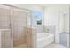 Bathroom featuring a glass shower and a separate soaking tub at 11296 Curio Dr, Brooksville, FL 34613