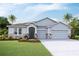 Charming single-Gathering home with a three-car garage, stone accents, and a well-manicured lawn at 11296 Curio Dr, Brooksville, FL 34613