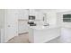 Modern kitchen with white cabinets, stainless steel appliances, and a spacious center island at 11296 Curio Dr, Brooksville, FL 34613