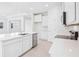 Contemporary kitchen with white cabinetry, sleek countertops, and stainless steel appliances at 11296 Curio Dr, Brooksville, FL 34613