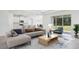 Bright and airy living room flows into the modern kitchen, with large windows and an open layout at 11296 Curio Dr, Brooksville, FL 34613