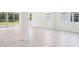 Bright living room features large glass sliding doors and neutral tile flooring at 11296 Curio Dr, Brooksville, FL 34613