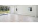 Bright living room features multiple windows, and neutral tile flooring at 11296 Curio Dr, Brooksville, FL 34613