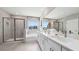 Modern bathroom with double sinks, spacious shower, and a separate bathtub with large window at 11352 Curio Dr, Brooksville, FL 34613