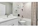 Well-lit bathroom featuring a vanity, toilet, shower/tub combo with a patterned shower curtain at 11352 Curio Dr, Brooksville, FL 34613