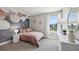 Charming bedroom with a pink quilt, decorative wallpaper, and bright natural light at 11352 Curio Dr, Brooksville, FL 34613