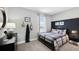 Decorated bedroom featuring a bed, mounted fish wall decor, and bright natural lighting at 11352 Curio Dr, Brooksville, FL 34613