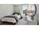 Cozy bedroom with comfortable bed, dresser, and a bright window view at 11352 Curio Dr, Brooksville, FL 34613