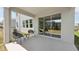 Comfortable covered patio with modern chairs and sliding glass doors to the backyard at 11352 Curio Dr, Brooksville, FL 34613