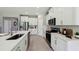 Modern kitchen featuring white cabinets, stainless steel appliances and an island with a sink at 11352 Curio Dr, Brooksville, FL 34613