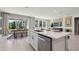 Bright, open kitchen with stainless appliances, an island, and an adjacent dining area at 11352 Curio Dr, Brooksville, FL 34613