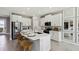 Modern kitchen with stainless steel appliances, an island with breakfast bar, and white cabinetry at 11352 Curio Dr, Brooksville, FL 34613