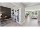 Bright, open-concept living room with dining area and view to study with paneled accent wall at 11352 Curio Dr, Brooksville, FL 34613
