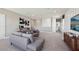 Spacious living room with plush carpeting, comfortable seating, and modern decor at 11352 Curio Dr, Brooksville, FL 34613
