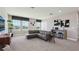 Open living room with a large sectional sofa, stylish decor, and plenty of natural light at 11352 Curio Dr, Brooksville, FL 34613