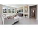 Bright living room featuring large windows, comfortable seating, and stylish decor with neutral tones at 11352 Curio Dr, Brooksville, FL 34613
