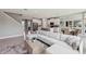 Open concept living space featuring an expansive sofa, modern kitchen, and contemporary decor with a staircase at 11352 Curio Dr, Brooksville, FL 34613
