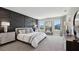 Serene main bedroom with textured accent wall, plush carpet, and views of the outdoors at 11352 Curio Dr, Brooksville, FL 34613