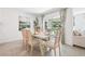 Bright dining area with modern decor, a dining table set for six, and sliding doors to the backyard at 11766 Memorial Dr, Brooksville, FL 34613
