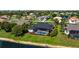 Aerial view of the home with a screened-in pool in a landscaped backyard, surrounded by a well-maintained neighborhood at 305 Lake Tahoe Ct, Englewood, FL 34223