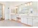 Bathroom featuring dual sinks, granite countertops, and ample cabinet space at 305 Lake Tahoe Ct, Englewood, FL 34223