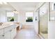 Bright bathroom with double vanity, soaking tub, and a glass enclosed shower at 305 Lake Tahoe Ct, Englewood, FL 34223
