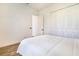 Well-lit bedroom with wood floors, a comfy bed, and a spacious closet for optimal storage solutions at 305 Lake Tahoe Ct, Englewood, FL 34223
