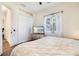 Serene bedroom with soft lighting, large window, and ample closet space, offering a peaceful retreat at 305 Lake Tahoe Ct, Englewood, FL 34223
