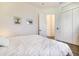 Relaxing bedroom featuring a plush bed with crisp white linens, and complemented by tasteful artwork at 305 Lake Tahoe Ct, Englewood, FL 34223